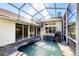 The serene pool with a rock waterfall and plenty of sunshine makes for a perfect backyard paradise at 4942 Hidden Oaks Ln, Sarasota, FL 34232
