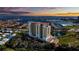 Stunning aerial view of a waterfront condominium building with red tile roof and picturesque harbor views at sunset at 501 Haben Blvd # 202, Palmetto, FL 34221