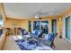 Comfortable covered balcony with fan, outdoor seating, and tile flooring at 501 Haben Blvd # 202, Palmetto, FL 34221