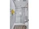 Bathroom featuring tiled shower with glass door, grey walls, and wood-look flooring at 501 Haben Blvd # 202, Palmetto, FL 34221