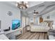 Bright bedroom featuring a tray ceiling, wood floors, and a view of the water on TV at 501 Haben Blvd # 202, Palmetto, FL 34221