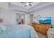Comfortable bedroom with tray ceiling, ceiling fan, and mirrored closet doors at 501 Haben Blvd # 202, Palmetto, FL 34221