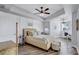 Serene bedroom with a decorative ceiling, ample natural light, and wood flooring at 501 Haben Blvd # 202, Palmetto, FL 34221