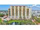 Beautiful multi-story condo building with balconies, manicured landscaping, water feature, and community pool at 501 Haben Blvd # 202, Palmetto, FL 34221