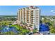 Exterior shot of the luxurious high rise building, pool, and lush landscaping at 501 Haben Blvd # 202, Palmetto, FL 34221