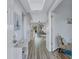 Bright hallway with wood flooring and a glimpse into the open-concept living area at 501 Haben Blvd # 202, Palmetto, FL 34221