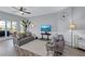 Comfortable living room with a ceiling fan, balcony access, and stylish decor at 501 Haben Blvd # 202, Palmetto, FL 34221