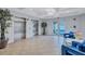 Inviting lobby area with tile floors, stylish seating, decorative plants, elevators, and access to the parking garage at 501 Haben Blvd # 202, Palmetto, FL 34221