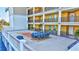 Spacious outdoor patio with blue seating and grill, great for entertaining friends and enjoying the outdoors at 501 Haben Blvd # 202, Palmetto, FL 34221