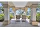 Serene outdoor seating beneath an arched portico overlooking a pond and the lush landscaping at 501 Haben Blvd # 202, Palmetto, FL 34221