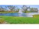 Beautiful pond with fountain surrounded by lush green grass and mature trees at the community at 501 Haben Blvd # 202, Palmetto, FL 34221