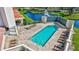 Relaxing outdoor pool area with lounge chairs, brick pavers, and lovely landscaping near the lake at 501 Haben Blvd # 202, Palmetto, FL 34221