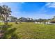Expansive backyard with lush lawn, waterfront views, and Adirondack seating, ideal for relaxing and entertaining at 504 59Th St, Holmes Beach, FL 34217
