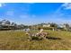 Backyard setting with fire pit, seating, canal views, and lush greenery, perfect for relaxation at 504 59Th St, Holmes Beach, FL 34217