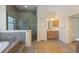 Large bathroom with shower, jacuzzi tub, and wood cabinet vanity at 504 59Th St, Holmes Beach, FL 34217