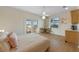 Cozy bedroom with patio access, light walls, wood floors, and an adjacent bar area at 504 59Th St, Holmes Beach, FL 34217