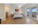 Sunlit bedroom featuring wood floors, patio access, light walls, and tasteful décor at 504 59Th St, Holmes Beach, FL 34217