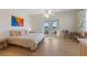 Bright bedroom featuring wood flooring, white walls, contemporary décor, and outdoor access at 504 59Th St, Holmes Beach, FL 34217