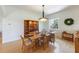 Dining area with hardwood flooring, stylish lighting, and built-in display cabinet at 504 59Th St, Holmes Beach, FL 34217
