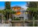 Waterfront home with multiple balconies, private dock and lush tropical landscaping at 504 59Th St, Holmes Beach, FL 34217