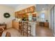 Open kitchen features light wood cabinetry, a breakfast bar, and lots of counter space for cooking and entertaining at 504 59Th St, Holmes Beach, FL 34217
