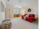 Bright living area with a red sofa, work station, natural lighting, and cozy decor at 504 59Th St, Holmes Beach, FL 34217
