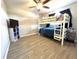 Cozy bedroom with a bunk bed, ceiling fan, and tile floors at 5104 Silver Bell Dr, Port Charlotte, FL 33948