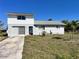 Charming two-story home with a garage and a well-maintained front yard at 5104 Silver Bell Dr, Port Charlotte, FL 33948