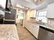 Modern kitchen featuring stainless steel appliances, a stone backsplash, and a view into the laundry room at 5104 Silver Bell Dr, Port Charlotte, FL 33948