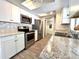 Modern kitchen featuring stainless steel appliances, stone backsplash, and a sink with window at 5104 Silver Bell Dr, Port Charlotte, FL 33948