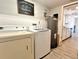 Well-lit laundry room features a washer, dryer, and decorative 'Laundry Room' sign at 5104 Silver Bell Dr, Port Charlotte, FL 33948