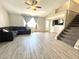 Comfortable living room with carpeted staircase, tile floors, backyard access, and ceiling fan at 5104 Silver Bell Dr, Port Charlotte, FL 33948