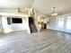 Open-concept living room with tiled flooring, a staircase, and sliding glass doors leading to the backyard at 5104 Silver Bell Dr, Port Charlotte, FL 33948