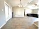 Open-concept living room with wood-look tile flooring and natural light from sliding glass doors at 5104 Silver Bell Dr, Port Charlotte, FL 33948
