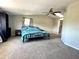 A large main bedroom with a queen size bed, closet, and ceiling fan at 5104 Silver Bell Dr, Port Charlotte, FL 33948