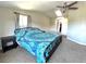 The main bedroom of the home featuring a bed, side table, and ceiling fan at 5104 Silver Bell Dr, Port Charlotte, FL 33948