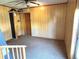 Modest sized paneled room with linoleum flooring and a door to the outside at 5104 Silver Bell Dr, Port Charlotte, FL 33948