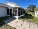 Exterior view of a sunroom addition, with sliding screen windows and an outside patio at 5104 Silver Bell Dr, Port Charlotte, FL 33948