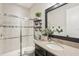 Bathroom featuring double sinks and granite countertops and a shower with glass doors at 5203 Rushmere Ct, Palmetto, FL 34221
