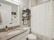 Well-lit bathroom featuring granite countertop, vanity, toilet, and decorative shelving at 5203 Rushmere Ct, Palmetto, FL 34221