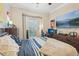 Relaxing bedroom featuring a ceiling fan, media center, and large window at 5203 Rushmere Ct, Palmetto, FL 34221