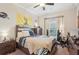 Comfortable bedroom with a ceiling fan, sports decor, and a large window at 5203 Rushmere Ct, Palmetto, FL 34221