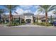 Beautiful community clubhouse with tropical landscaping, a paved entrance, and a stylish architectural design at 5203 Rushmere Ct, Palmetto, FL 34221