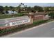 Attractive stone community entrance sign surrounded by lush greenery at 5203 Rushmere Ct, Palmetto, FL 34221