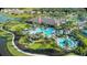 Aerial view showcasing a resort-style community pool surrounded by lush landscaping and amenities at 5203 Rushmere Ct, Palmetto, FL 34221
