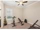 Exercise room featuring carpeted floors, an exercise bike, a weight bench, and free weights at 5203 Rushmere Ct, Palmetto, FL 34221