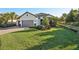 Well-maintained home showcasing a lush lawn, mature landscaping, and an expansive paver driveway at 5203 Rushmere Ct, Palmetto, FL 34221
