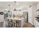This kitchen features an island with bar stool seating, granite countertops, stainless steel appliances, and hardwood floors at 5203 Rushmere Ct, Palmetto, FL 34221