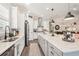 Bright kitchen boasts a large island, granite countertops, pendant lighting and views to the living and dining areas at 5203 Rushmere Ct, Palmetto, FL 34221