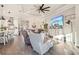 Open concept living room boasts hardwood floors, modern decor, and lots of natural light from the picture windows at 5203 Rushmere Ct, Palmetto, FL 34221